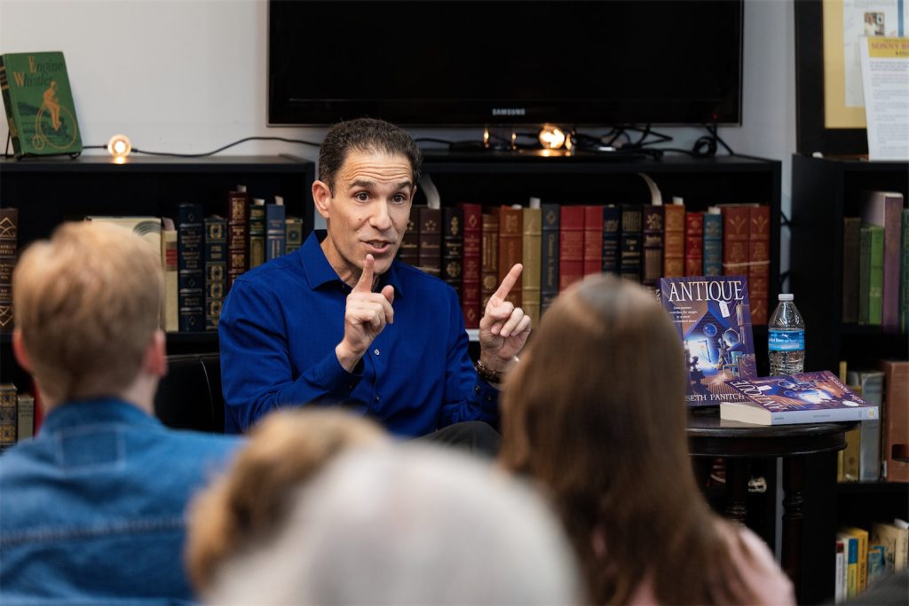 Seth Panitch Speaking gesturing with two index fingers held about 8 inches apart