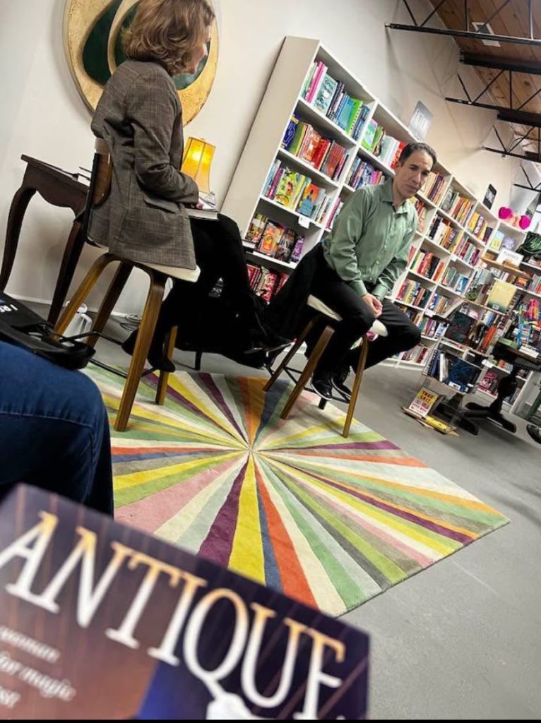 Seth Panitch Speaking from the view of listener with the books in the listeners lap